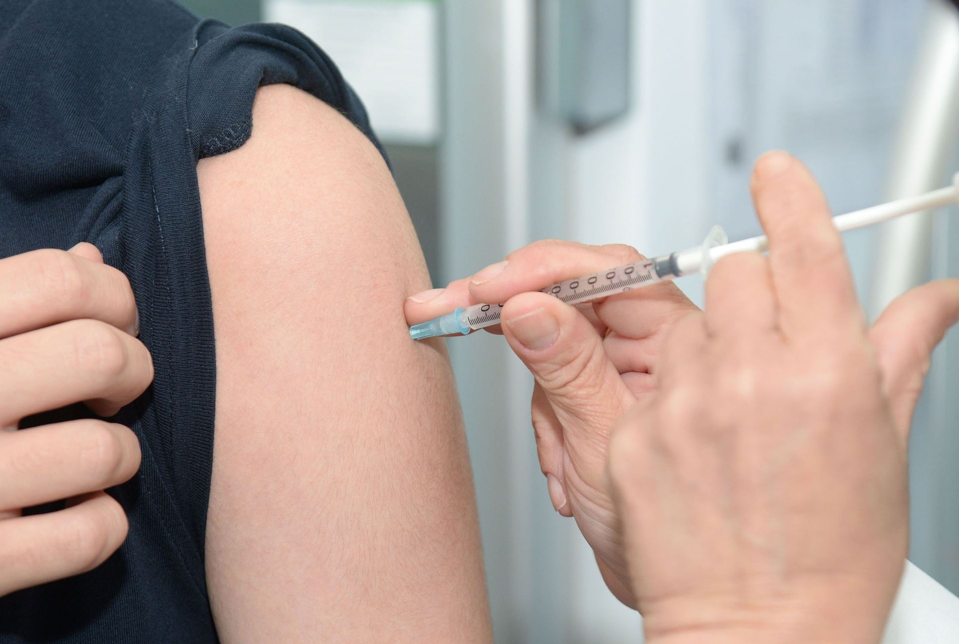a person being injected in the arm